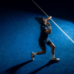 Athlete in Combi Deal Navy padel clothing set, captured mid-action, demonstrating dynamic movement and flexibility on the court.
