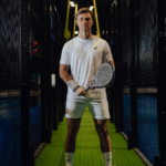 Athlete wearing the Combi Deal White padel clothing set, posing on the court with a racket, showcasing style, comfort, and performance.