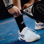 Athlete wearing black Performance Socks, showcasing comfort and support on the court. Perfect for padel players looking for quality gear.