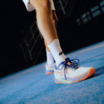 Athlete wearing white Performance Socks, showcasing their comfort and style while in motion on the padel court. Ideal for optimal performance and support.