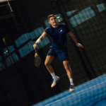 Athlete wearing the Performance Shirt Navy, captured mid-action on the court, showcasing its flexibility, comfort, and performance features.