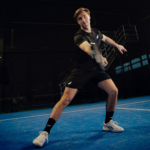 Athlete wearing the Performance Short Black, in motion on the padel court, demonstrating the shorts’ flexibility, fit, and performance during an intense match.