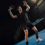 Athlete wearing the Performance Short Black, captured mid-action on the padel court, highlighting the shorts’ fit, flexibility, and performance during intense movement.