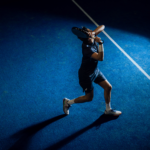 Athlete wearing the Performance Short Navy, captured mid-swing on the padel court, highlighting the shorts' flexibility and comfort during intense play.